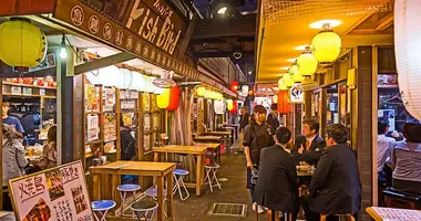 A busy street lined with izakaya