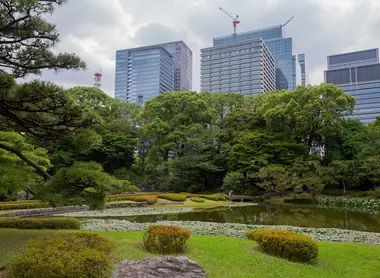 Pond in Imperial Palace gardens with skyscrapers in the background