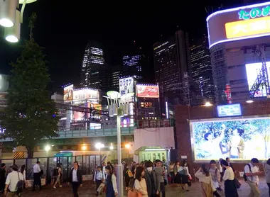 Nightly Shinjuku cityscape seen from outside the main entrance of Seibu Shinjuku Station, Tokyo