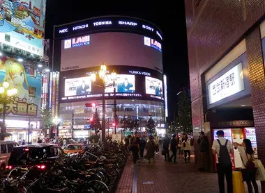 Yunika Building with its video screens in front of the main entrance of Seibu Shinjuku Station