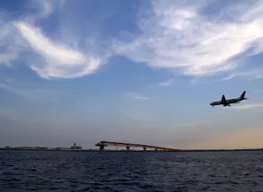 View of a landing airplane from Jonanjima Seaside Park