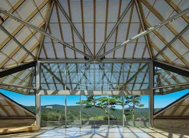 The building of the Miho Museum and the large bay window overlooking a landscape of pines and maples