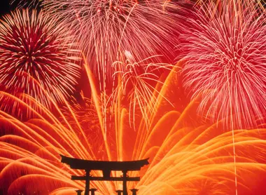 Fireworks behind the famous Miyajima torii gate. Fireworks before the famous Miyajima torii.