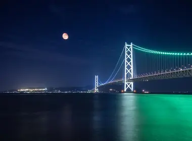 The lights at night on the Akashi Kaikyo Bridge.