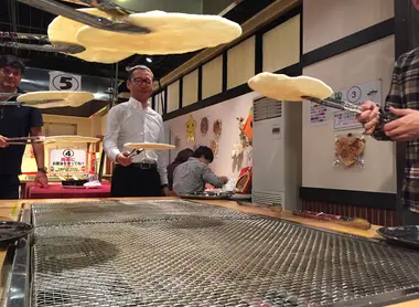 La cuisson des senbei au-dessus des grilles