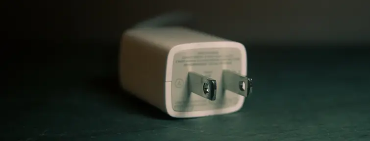 US phone charger on a dark background