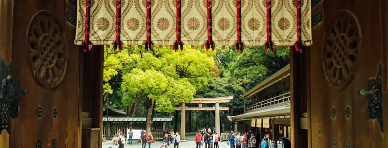 Door looking out to a crowded courtyard and torii