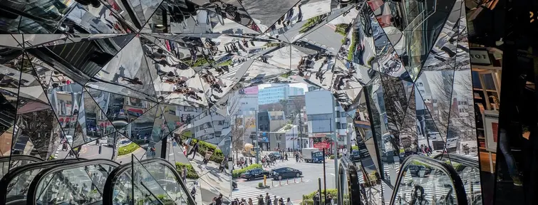 Different reflections from mirrors above an escalator in Omotesando