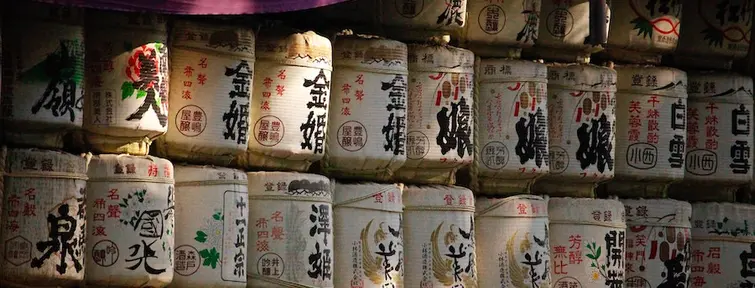 Piled up sake barrels with Japanese labels