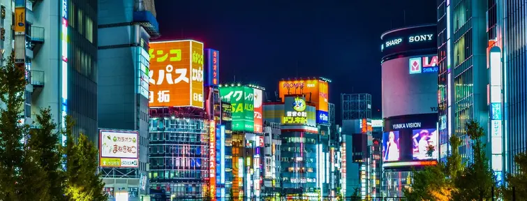 Neon lights of Shinjuku with car lights from a busy road